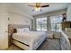 Serene main bedroom with a tufted headboard, ceiling fan, and bright windows at 1727 Pearl St # 205, Denver, CO 80203