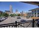 Parking lot with multiple cars and a view of the city skyline in the background at 1727 Pearl St # 205, Denver, CO 80203