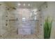 Oversized walk-in shower featuring dual shower heads, a pebble floor, and a built-in bench at 1727 Pearl St # 205, Denver, CO 80203