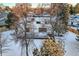 Aerial view of a home with a large deck and snowy yard at 6144 S Fulton St, Englewood, CO 80111