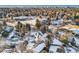 An aerial view of a house and neighborhood during winter at 6144 S Fulton St, Englewood, CO 80111