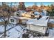 Snow covered aerial view of a charming home with a two-car garage at 6144 S Fulton St, Englewood, CO 80111