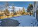 Spacious back deck with snow covering, offering a peaceful outdoor space at 6144 S Fulton St, Englewood, CO 80111