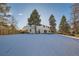 Large backyard with snow-covered grass and a modern home in the background at 6144 S Fulton St, Englewood, CO 80111