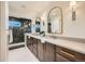 Modern bathroom with double vanity, walk-in shower, and dark tile at 6144 S Fulton St, Englewood, CO 80111