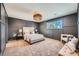 Serene bedroom with plush carpet and gray accent wall at 6144 S Fulton St, Englewood, CO 80111