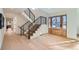 Bright and airy entryway with hardwood floors and a staircase at 6144 S Fulton St, Englewood, CO 80111