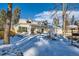 Two-story house with white exterior, snowy front yard, and a tree at 6144 S Fulton St, Englewood, CO 80111