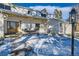 Inviting front entrance with a wooden door and a porch swing at 6144 S Fulton St, Englewood, CO 80111