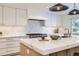 Gourmet kitchen with marble countertops and modern lighting at 6144 S Fulton St, Englewood, CO 80111