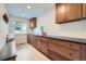 Laundry room with wood cabinets, black countertop and built-in bench at 6144 S Fulton St, Englewood, CO 80111