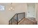 Modern staircase with black railing and light colored floors at 6144 S Fulton St, Englewood, CO 80111