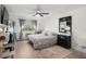Bright bedroom featuring a ceiling fan, large window, and a comfortable bed at 9150 E Center Ave # 7C, Denver, CO 80247