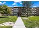 Attractive multi-story apartment building with manicured lawns and mature trees at 9150 E Center Ave # 7C, Denver, CO 80247