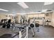 Bright fitness center featuring modern equipment, windows, and a mirrored wall for a complete workout experience at 9150 E Center Ave # 7C, Denver, CO 80247