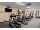 Bright fitness center featuring modern cardio machines, television, and mirrored wall for a complete workout experience at 9150 E Center Ave # 7C, Denver, CO 80247