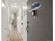 Inviting foyer hallway with light wood floors and neutral wall colors at 9150 E Center Ave # 7C, Denver, CO 80247