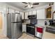 Updated kitchen featuring stainless steel appliances, white cabinets and light wood flooring at 9150 E Center Ave # 7C, Denver, CO 80247