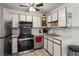Well-maintained kitchen featuring sleek appliances, and white cabinets at 9150 E Center Ave # 7C, Denver, CO 80247