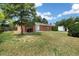 Spacious backyard with mature trees and a storage shed, perfect for outdoor activities at 396 S Troy St, Aurora, CO 80012