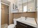 Bathroom featuring a shower and glass door, with modern vanity and ample storage space at 396 S Troy St, Aurora, CO 80012