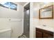 This is a bathroom with a glass door shower, vanity and window at 396 S Troy St, Aurora, CO 80012