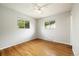 Bedroom with hardwood floors and two windows offers natural light and a view outside at 396 S Troy St, Aurora, CO 80012