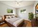 Cozy bedroom featuring hardwood floors, large windows, and a comfortable queen-sized bed at 396 S Troy St, Aurora, CO 80012