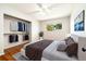 Bright bedroom featuring hardwood floors, a closet, and a large window at 396 S Troy St, Aurora, CO 80012