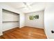 Bedroom with hardwood floors, neutral paint, closet, and window provides a bright space at 396 S Troy St, Aurora, CO 80012