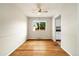 Bright dining room with hardwood floors and a window offering natural light at 396 S Troy St, Aurora, CO 80012