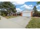 Lovely brick home with an attached garage and a driveway at 396 S Troy St, Aurora, CO 80012