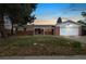 Charming brick home with a covered front porch and attached two-car garage at 396 S Troy St, Aurora, CO 80012