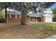 Charming brick home with a well-maintained front yard and mature trees at 396 S Troy St, Aurora, CO 80012