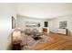 Bright living room featuring hardwood floors, a large window, and neutral decor at 396 S Troy St, Aurora, CO 80012