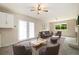 Comfortable living room with carpet, a fireplace, and doors that lead to the backyard at 396 S Troy St, Aurora, CO 80012