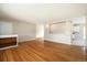 Spacious living room with hardwood floors, neutral paint, and view into other rooms at 396 S Troy St, Aurora, CO 80012