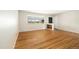 Bright living room features hardwood floors, large window with backyard view, and built-in shelves at 396 S Troy St, Aurora, CO 80012