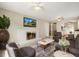 Cozy living room featuring a fireplace, hardwood floors, and an open view to the kitchen at 396 S Troy St, Aurora, CO 80012