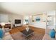 Open-concept living area with hardwood floors, a fireplace, and a view of the dining area at 396 S Troy St, Aurora, CO 80012