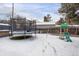 Backyard with trampoline, playset, and snowy ground at 9581 Green Ct, Westminster, CO 80031