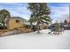 Large backyard with snow, a tree, playset, and fenced area at 9581 Green Ct, Westminster, CO 80031