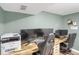 Basement office space with three monitors and a printer at 9581 Green Ct, Westminster, CO 80031