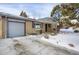 Brick ranch home with attached garage and snowy front yard at 9581 Green Ct, Westminster, CO 80031