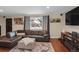 Spacious living room with sectional sofa, large window and fireplace at 9581 Green Ct, Westminster, CO 80031