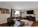 Spacious living room featuring a large sectional sofa and flat-screen TV at 9581 Green Ct, Westminster, CO 80031