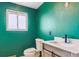 Updated bathroom with a teal feature wall at 8566 Flintwood Rd, Parker, CO 80138