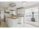 Kitchen with white cabinets, island and wood flooring at 8566 Flintwood Rd, Parker, CO 80138