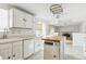 Kitchen features white cabinets, island and wood flooring at 8566 Flintwood Rd, Parker, CO 80138