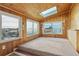 Sunroom with wood walls and skylight at 8566 Flintwood Rd, Parker, CO 80138